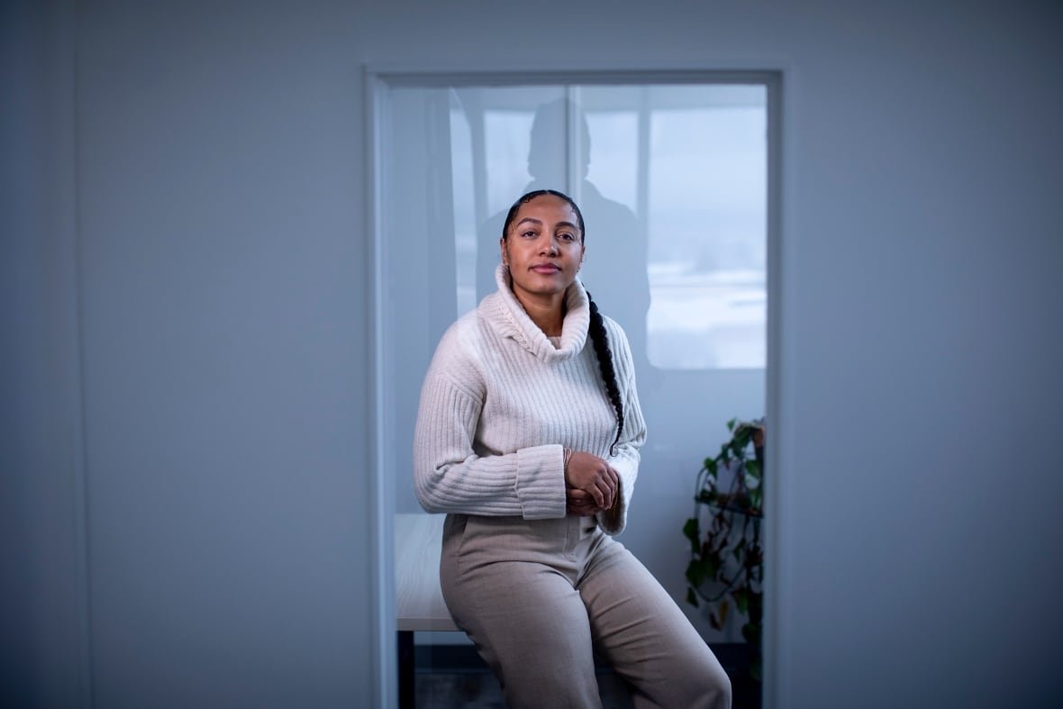 black-intimate-partner-violence-2 A light-skinned Black woman wears a white turtleneck sweater and looks straight at the camera.