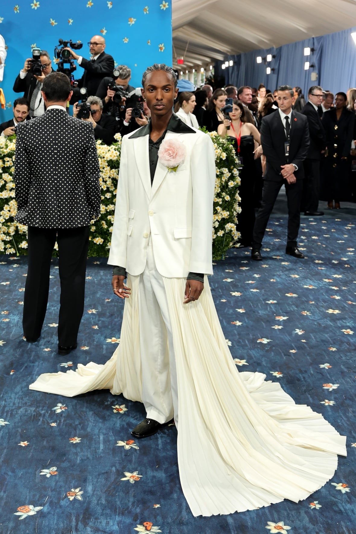 christian-latchman-2025-met-gala A man poses for a photo in an elaborate white suit.