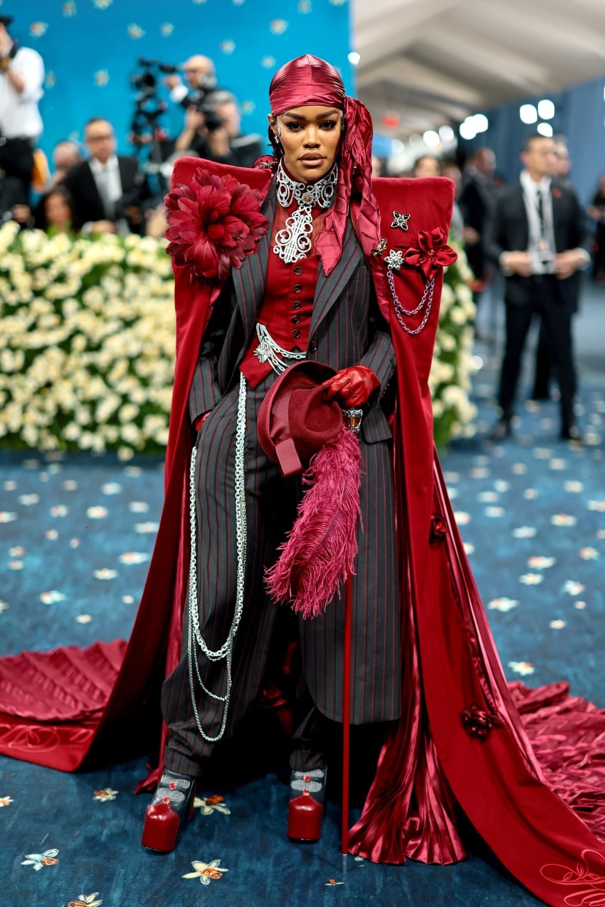teyana-taylor-2025-met-gala A woman poses for a photo in an elaborate red and black outfit.