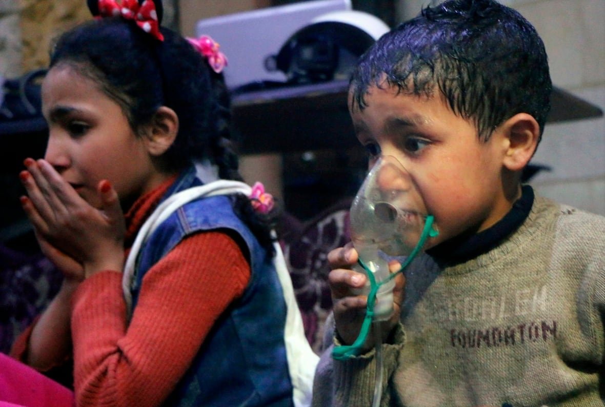 chemical-weapons-opcw-glance Two frightened children, one wearing a respirator.