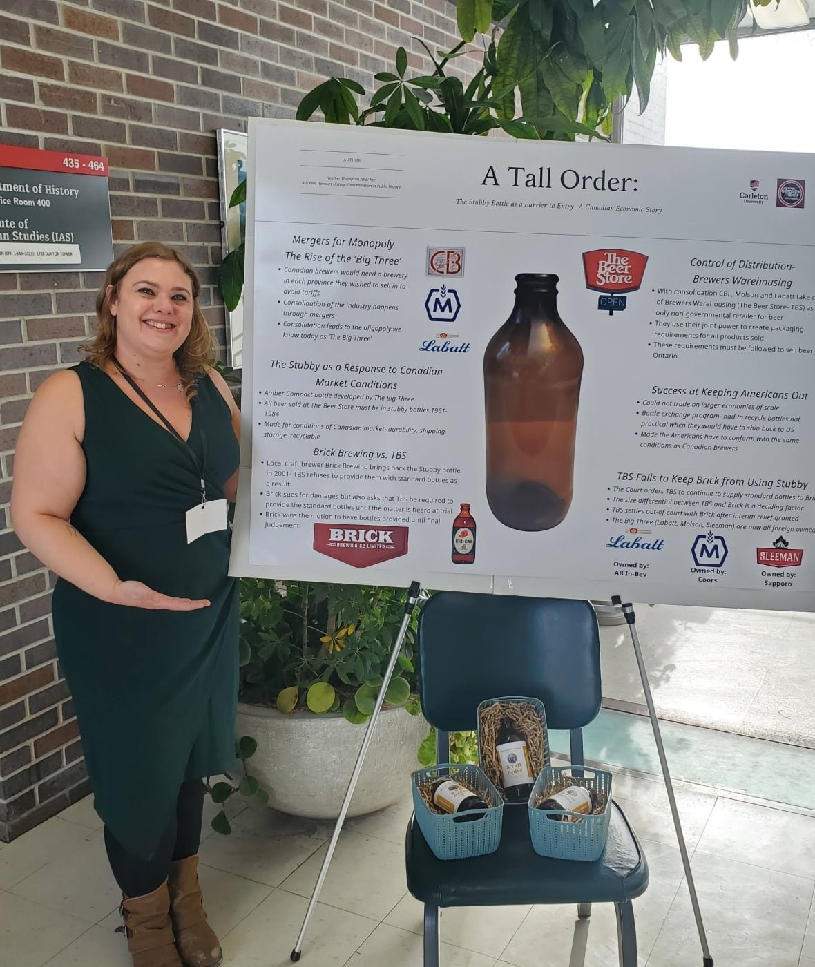 heather-thompson A woman standing beside a bristol board explainer about how the stubby was a non-tariff barrier to trade.