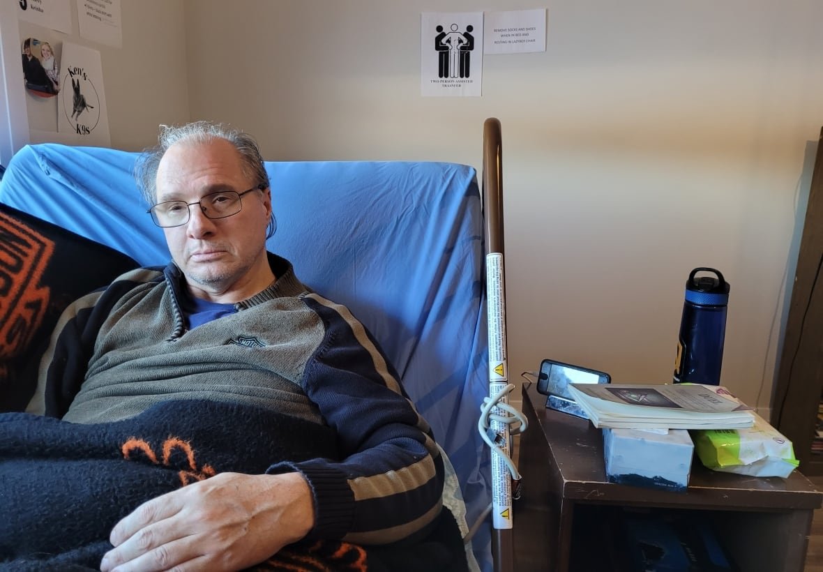 ken-rekowski-at-pathways-to-independence-2024 A man in a electric bed with a water bottle next to him on a bed side table.