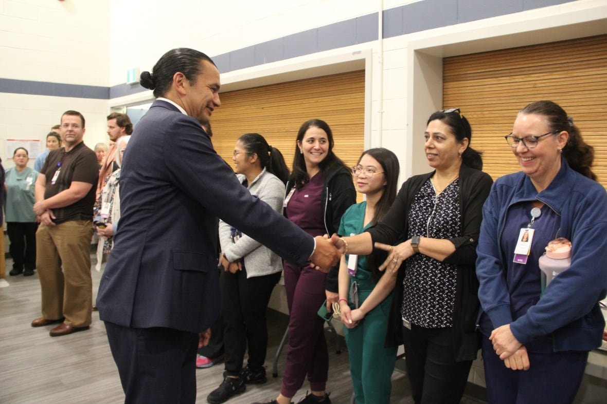 kinew-hiring-healthcare-workers A man shakes the hand of a woman