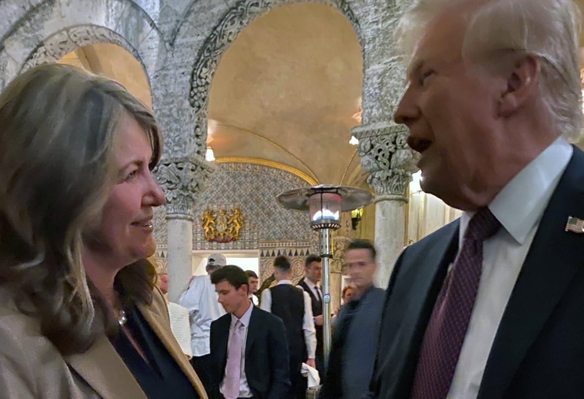 A woman and a man talk at a party.