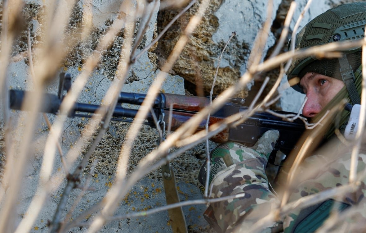 ukrainian-soldier-holding-a-gun-during-a-training-exercise A Ukrainian soldier holding a gun, during a training exercise.