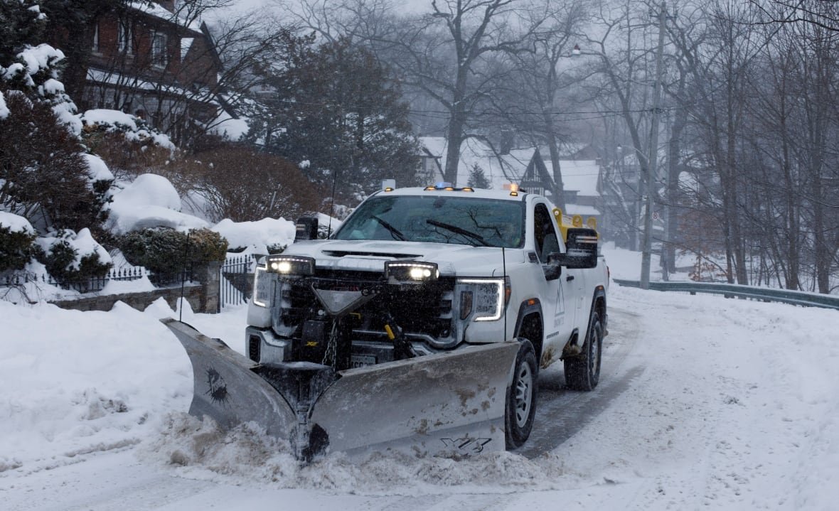 winter-snow Photo of a snowplow clearing a snowy suburban road