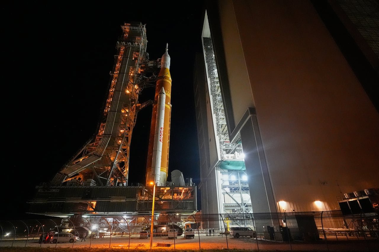vertical rocket about to enter a tall building in the dark