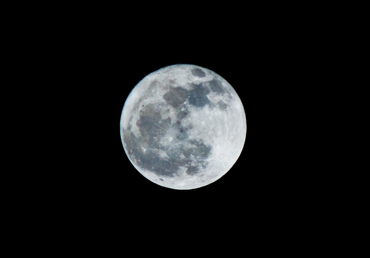 A moon with some blue hues in the mare.