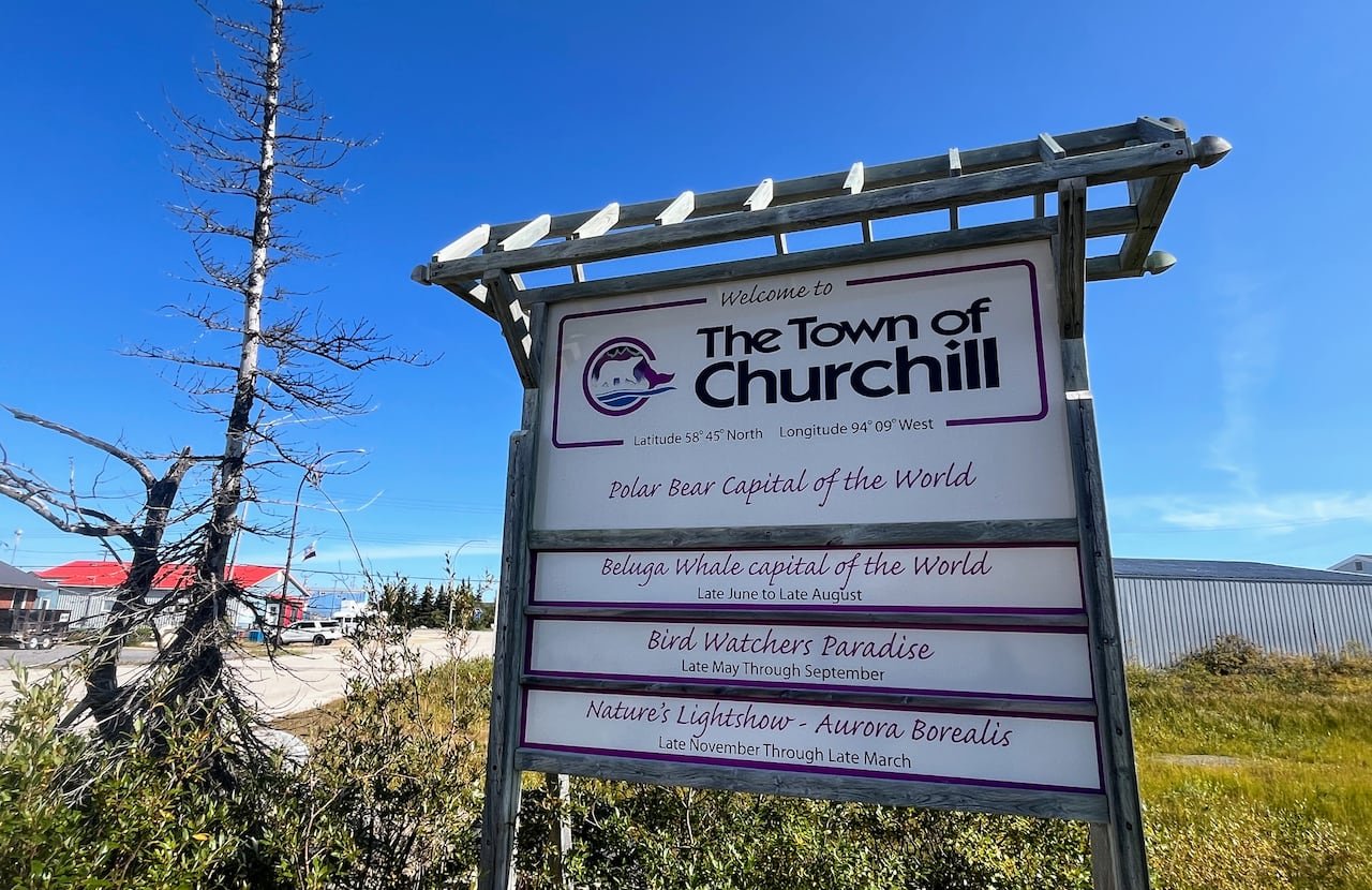 default-485 A sign reads "Churchill, Manitoba," and includes slogans like "polar bear capital of the world" and "beluga whale capital of the world."