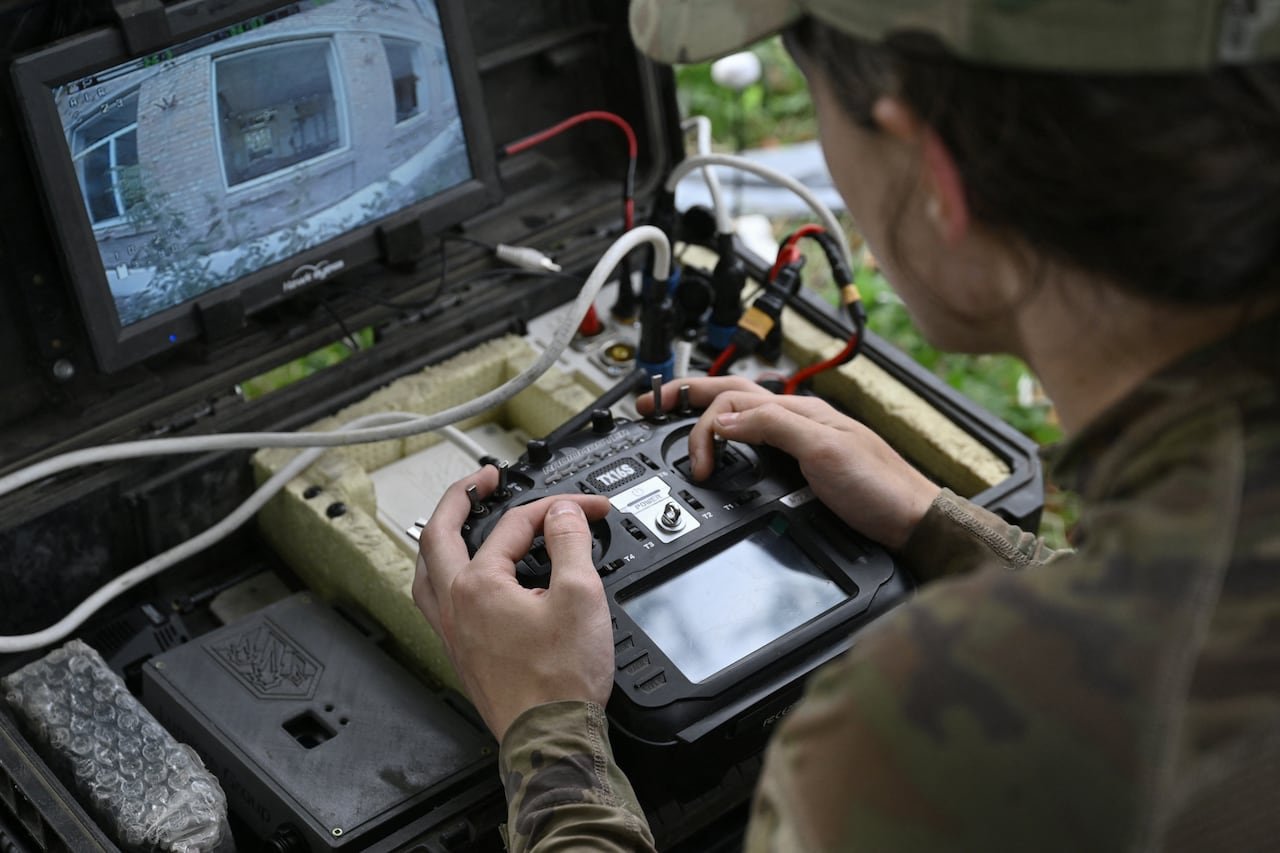 default-195 A soldier uses a drone, watching the drone's camera feed on a small monitor