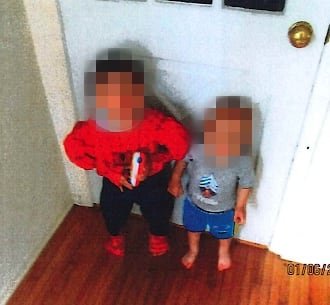 default-390 Two boys stand in a doorway. The older boy is wearing a Spiderman costume.